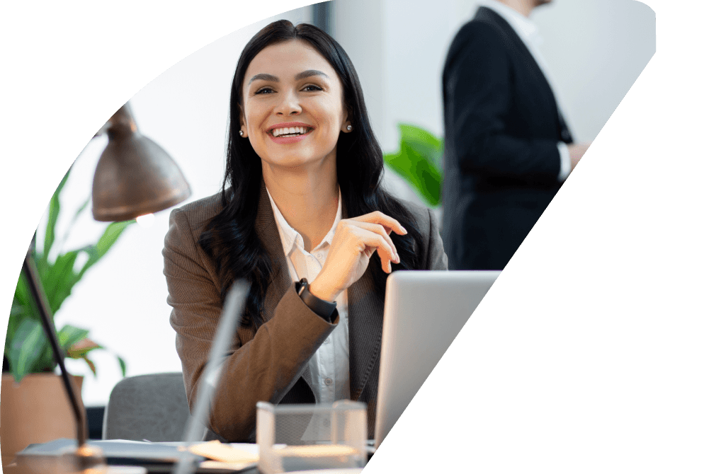 Professional woman smiling and working at her desk